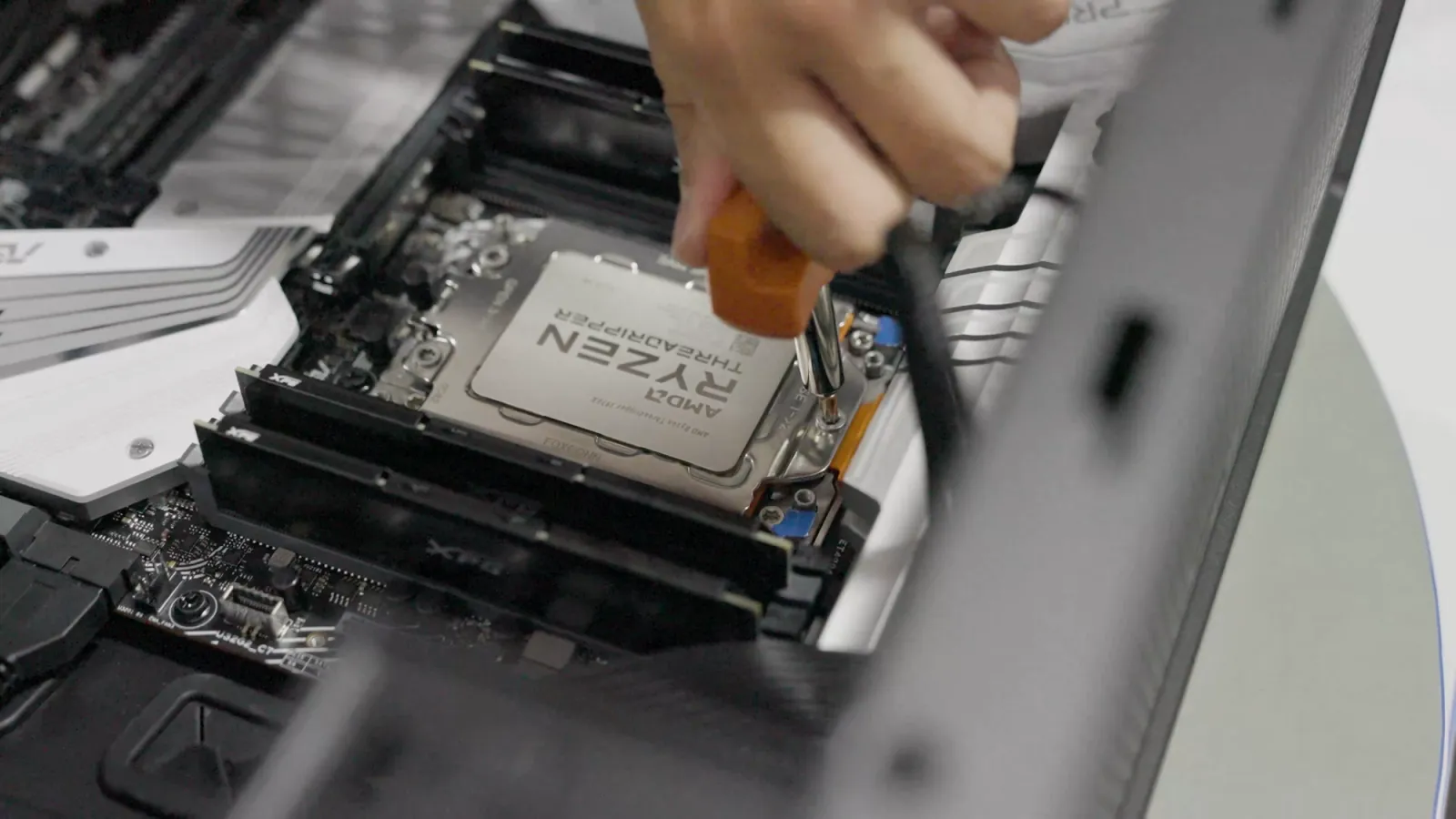 Hands seating a processor on a motherboard
