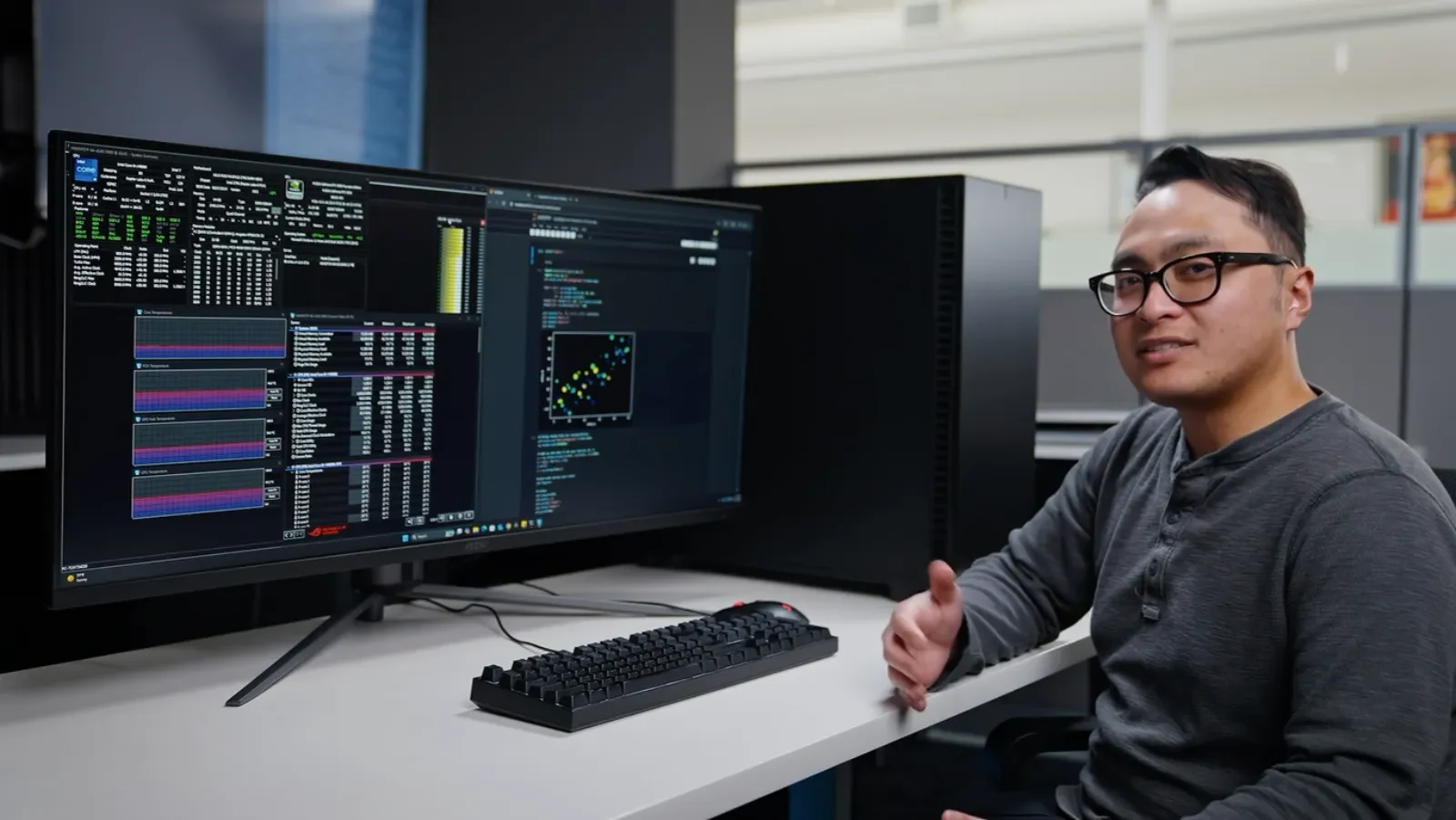 Digital Storm AI systems engineer at a dual-monitor benchmarking station