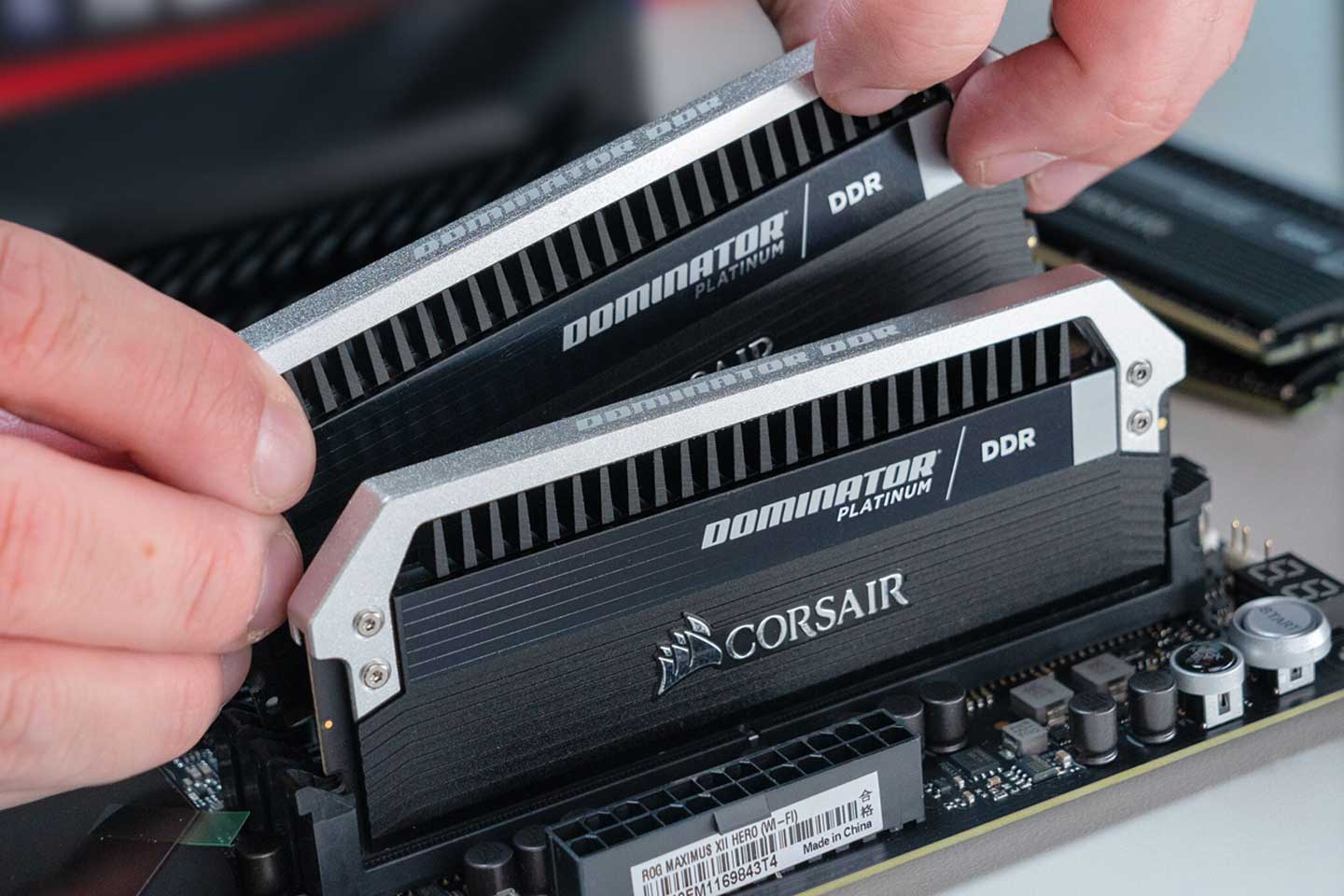 Ballistix memory cards being placed in a motherboard